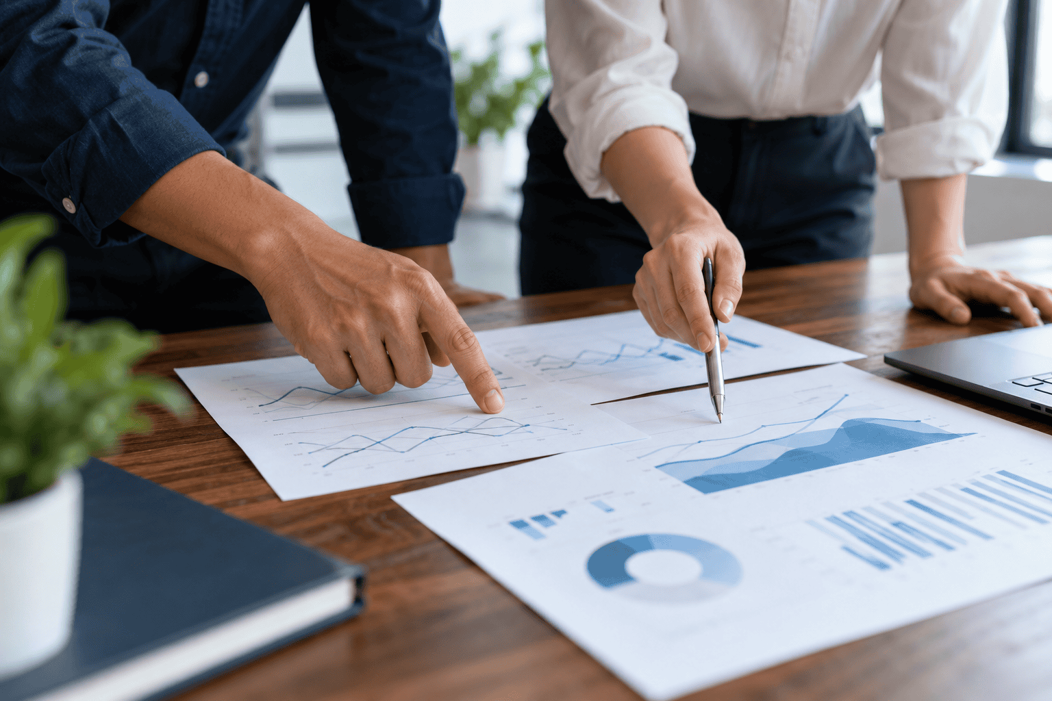 Two colleagues comparing illustrative reports while investigating a ranking change